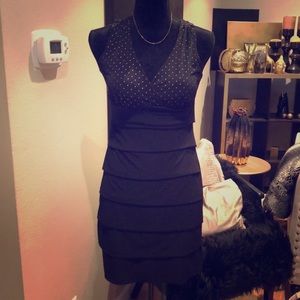 Black above knee dress with gold beading on top